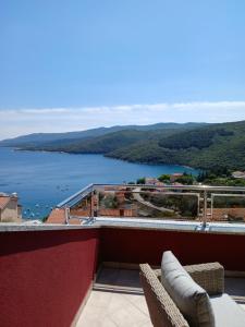 a balcony with a view of a body of water at RED House Rabac in Rabac