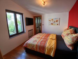a bedroom with a bed and a window at RED House Rabac in Rabac