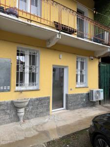 a yellow house with a balcony and a door at Milan house 2 in Samarate