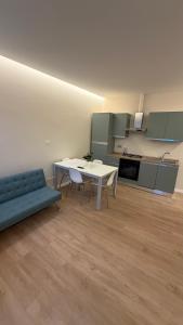 a living room with a table and a blue couch at Milan house 2 in Samarate