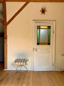 a chair in a room with a door at Appartement cosy au calme avec sauna in Kauffenheim