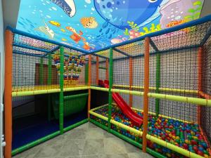 a childrens play room with a play structure with toys at Dom Wypoczynkowy Maniek in Białka Tatrzańska