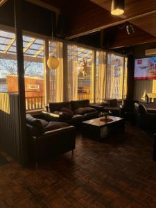 a living room with couches and a flat screen tv at Hotelli Pihkuri in Viitasaari