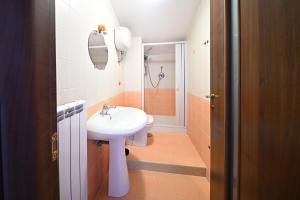 a bathroom with a sink and a shower at La Terrazza Sidicina Home in Teano +8 photos