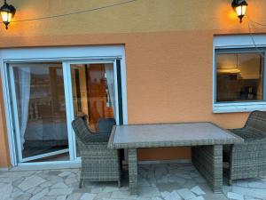 a table and chairs sitting in front of a building at Villa Nikki in Bilice