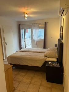 a bedroom with a large bed and a window at Villa Nikki in Bilice