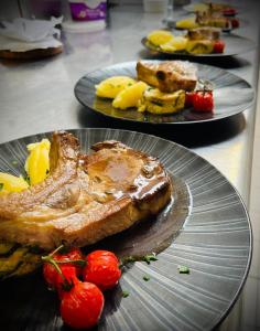 a plate of food with toast and fruit on a table at Logis Hotel Noemys Brive - Restaurant Le Teinchurier in Brive-la-Gaillarde