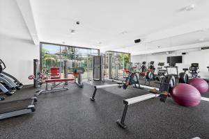 a gym with several treadmills and exercise machines at Beachfront sea view apartment in Petite Case Noyale