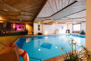 a large swimming pool in a building with a ceiling at hotel zentlinde in Mossautal