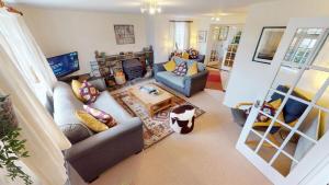 a living room with couches and a fireplace at CROYDE WHITE HOUSE 4 Bedrooms in Croyde