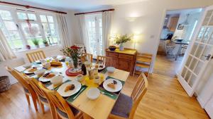 a dining room with a table with food on it at CROYDE WHITE HOUSE 4 Bedrooms in Croyde