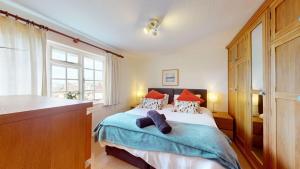 a bedroom with a bed and a large window at CROYDE WHITE HOUSE 4 Bedrooms in Croyde