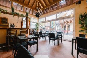 a restaurant with tables and chairs and a large window at hotel zentlinde in Mossautal