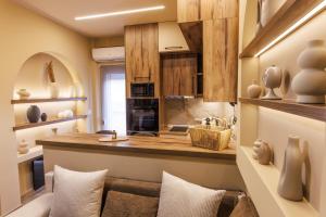 a kitchen with wooden cabinets and a counter top at Asana luxury apartment in Kozani