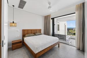 a bedroom with a bed and a large window at Beachfront sea view apartment in Petite Case Noyale +28 photos