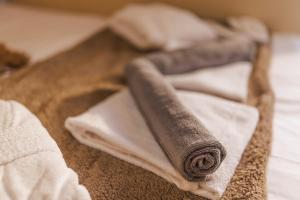 a rolled up towel sitting on top of a bed at Asana luxury apartment in Kozani