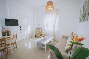a living room with a couch and a table at Villa Serena in Dauis