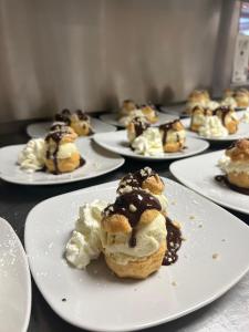 a group of plates of pastries on a table at Le Rocher Du Cerf in Le Lioran +36 photos