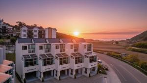 an apartment building with the sunset in the background at Gyeongju Modern Pool Villa in Gyeongju
