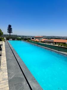 a swimming pool with blue water on top of a building at Unit 4913 - Ellipse Waterfall in Midrand