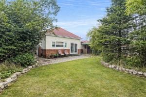 a white house with a yard with trees at 3 Bed Bungalow with Large Garden in Westoe