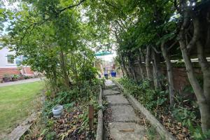 a garden with trees and a brick fence at 3 Bed Bungalow with Large Garden in Westoe