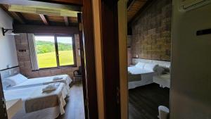 a room with three beds and a window at Casa Nahia Hostal Rural in Lorca +85 photos