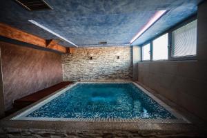 a large swimming pool in a room with a window at Verdisso Hotel & Restaurant in Demir Kapija