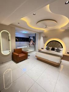 a large bedroom with a bed and a bath room at Hotel Palash Icon in Ahmedabad