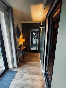 a hallway with a hallway leading to a room at L’Autre Nuit in Autreville
