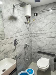 a bathroom with a toilet and a sink at Hotel Palash Icon in Ahmedabad +20 photos