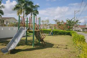 a playground with a slide in a park at Villa Serena in Dauis