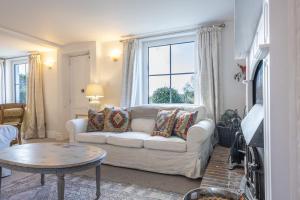 a living room with a white couch and a window at Hatchet Pond Cottage in Beaulieu