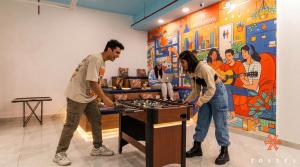 two men playing a game of chess in a room at Zostel Noida in Noida