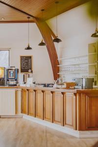 a kitchen with wooden cabinets and a counter top at Hôtel La Tour des Anglais in Mayenne