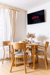 a dining room with a wooden table and chairs at Markowa Chata in Mizerna