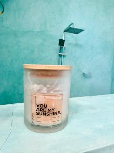 a container of soy candle sitting on a table at Olacoco by Olamanga in Jambiani