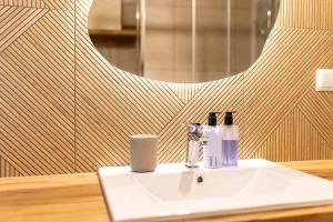 a bathroom with a white sink and a mirror at Markowa Chata in Mizerna +22 photos