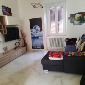 a living room with a couch and a tv at Wellness at home in Ancona