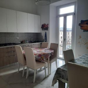 a kitchen with a table and chairs and a kitchen with a window at Wellness at home in Ancona