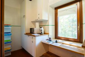 a small kitchen with a microwave and a window at Agriturismo Pimpinnacolo in Porto Ercole +214 photos
