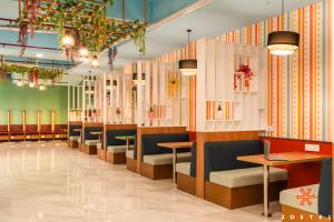 a restaurant with a row of chairs and tables at Zostel Noida in Noida