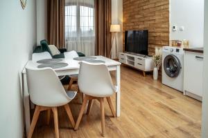 a kitchen and living room with a table and chairs at Relax & Luxury apartment in Veľká Lomnica