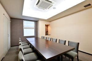 a conference room with a wooden table and chairs at Saijo Urban Hotel in Saijo +52 photos