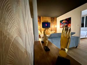 a living room with a blue couch and a table at Premium suite with jacuzzi 4 étoiles in Pleyber-Christ