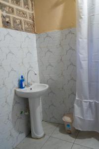 a bathroom with a sink and a toilet at Rasal homes in Gazi