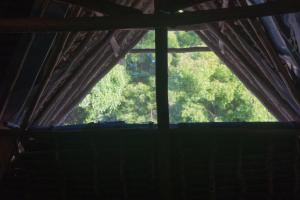a window in a room with a curtain at Rasal homes in Gazi