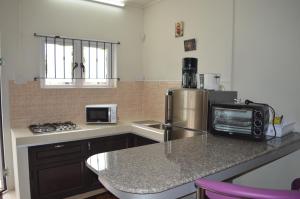 A kitchen or kitchenette at Ashmara Villa & Studio