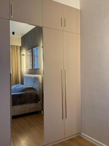 a large white cabinet in a room with a bed at Fatmanis 98 in Tbilisi City