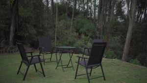 a group of chairs and a table in the grass at Ayana Gardens Ella in Ella